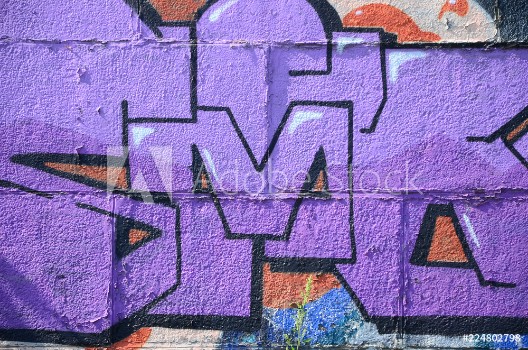 Bild på Fragment of graffiti drawings The old wall decorated with paint stains in the style of street art culture Colored background texture in purple tones